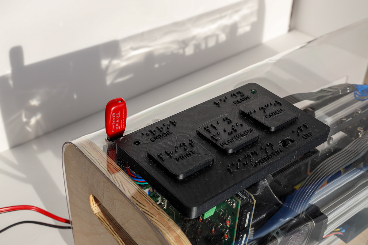 Picture of the Portabraille Printer physical interface, composed of 3 3D-printed buttons, 2 LEDs, and an ON/OFF switch, labeled with braille